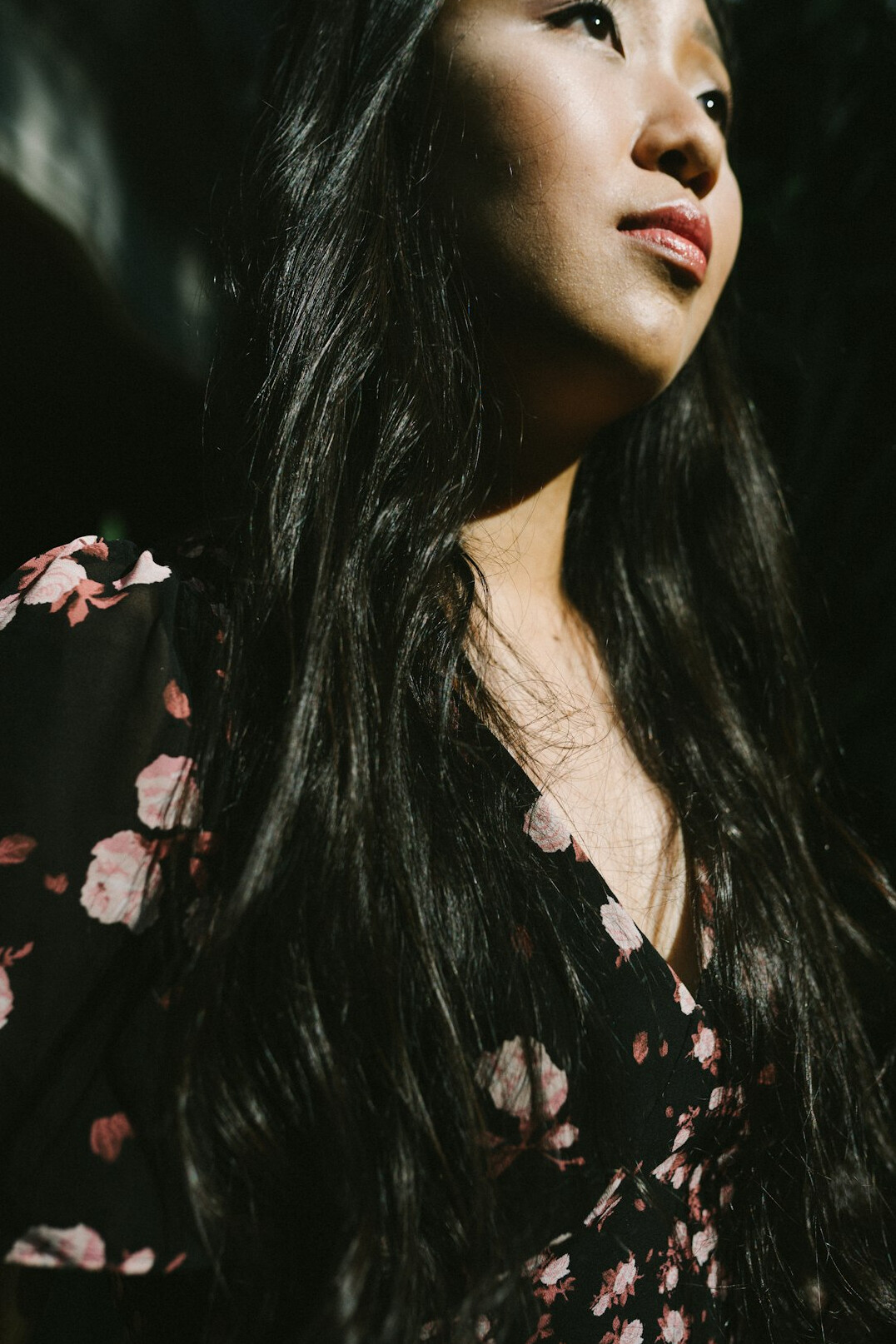 Portrait of a woman with long dark hair smiling