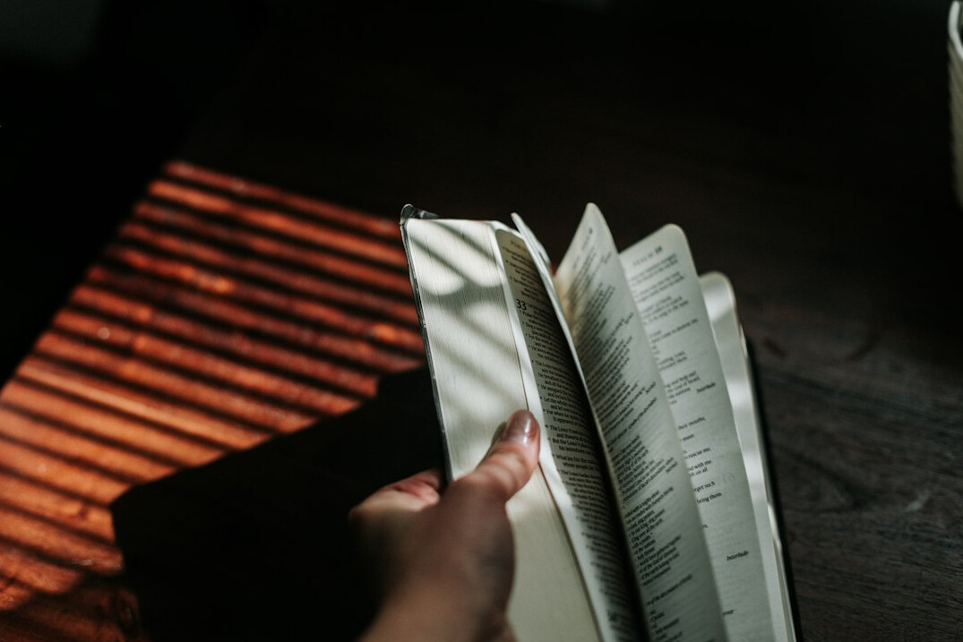 Hand writing reflections in an open notebook