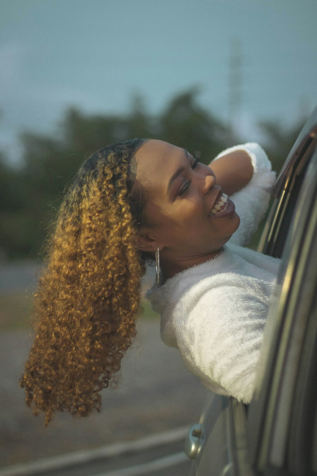 Portrait of a smiling woman with curly hair